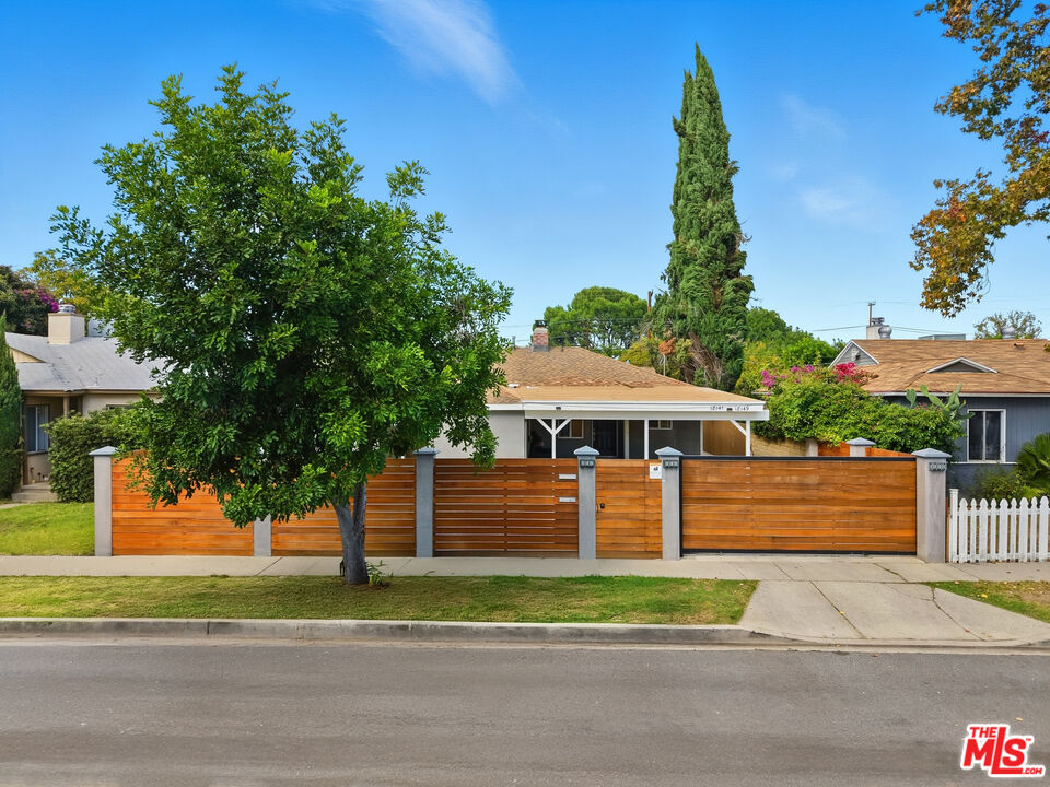 18149 Welby Way Reseda, CA 91335 - Photo 2 of 50 a front view of a house with a yard