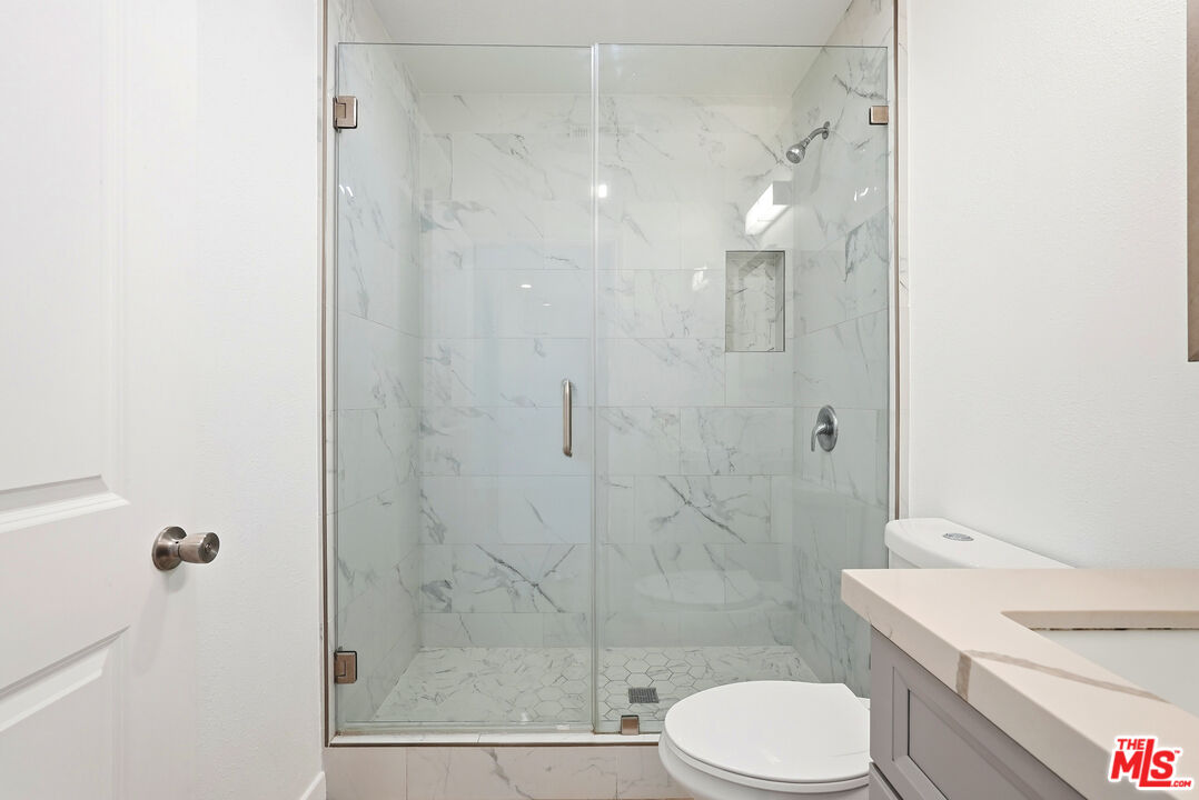 18149 Welby Way Reseda, CA 91335 - Photo 28 of 50 a bathroom with a shower a toilet and sink