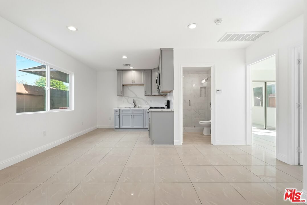 18149 Welby Way Reseda, CA 91335 - Photo 29 of 50 a view of a kitchen with refrigerator and windows