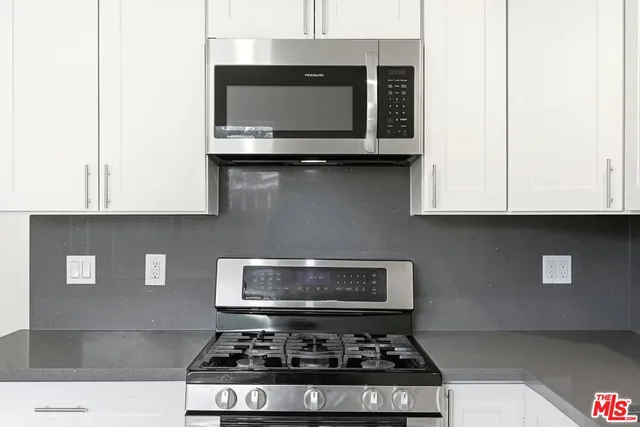 a stove top oven sitting inside of a kitchen