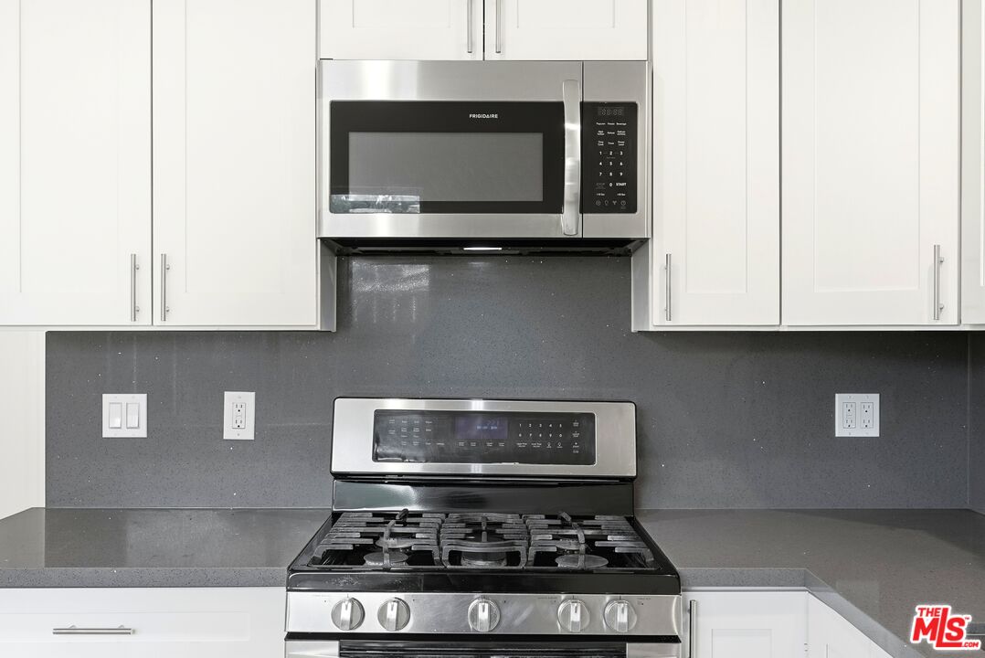 18149 Welby Way Reseda, CA 91335 - Photo 37 of 50 a stove top oven sitting inside of a kitchen