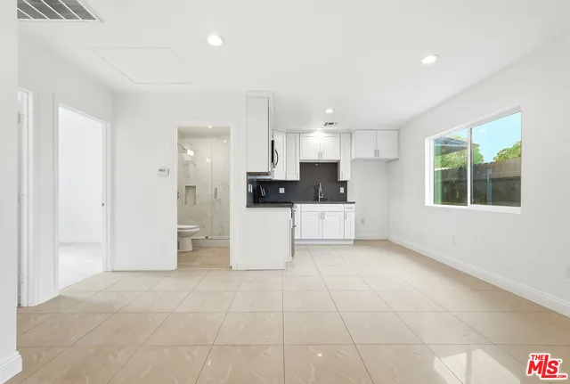 a kitchen with stainless steel appliances a refrigerator sink and cabinets