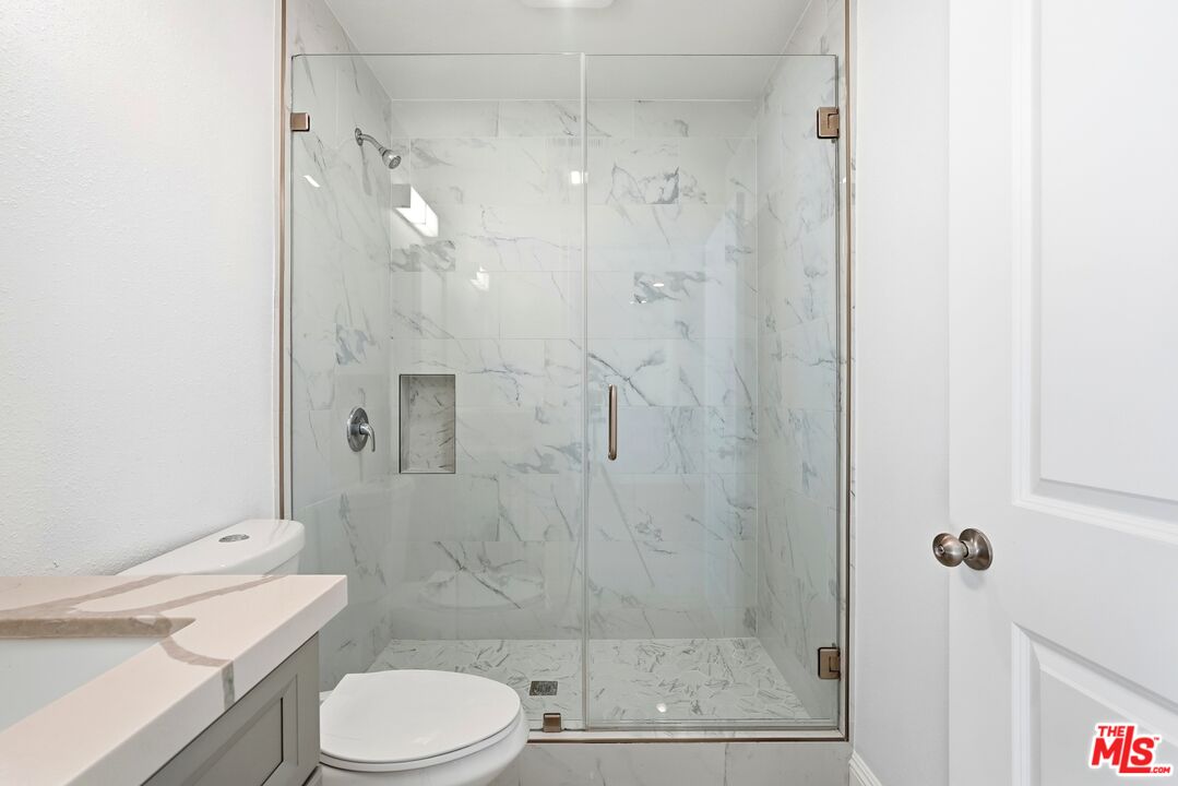 18149 Welby Way Reseda, CA 91335 - Photo 45 of 50 a bathroom with a shower a toilet and sink
