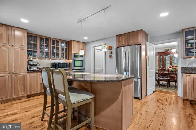 a kitchen with stainless steel appliances granite countertop a sink and cabinets