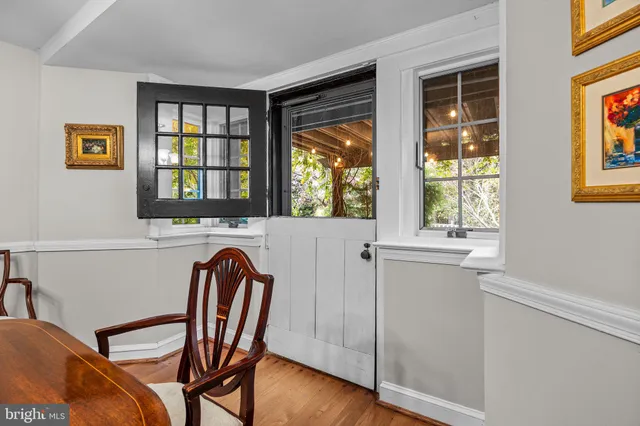 a living room with furniture a rug and a book shelf