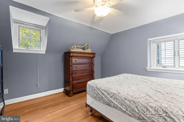 a spacious bedroom with a bed and ceiling fan