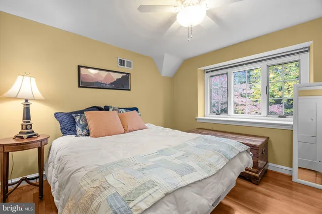 a spacious bathroom with a granite countertop sink mirror and a bathtub