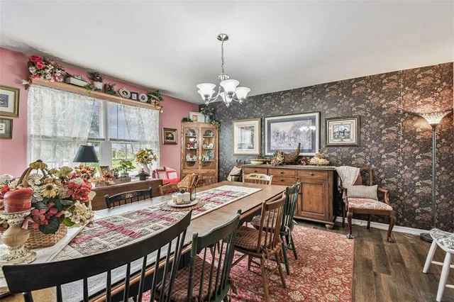 a view of a dining room with furniture and chandelier
