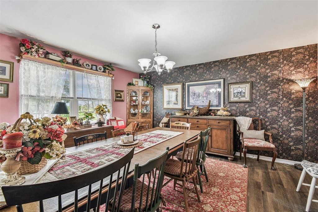 33937 St Benedict Road San Antonio, FL 33576 - Photo 11 of 58 a view of a dining room with furniture and a chandelier