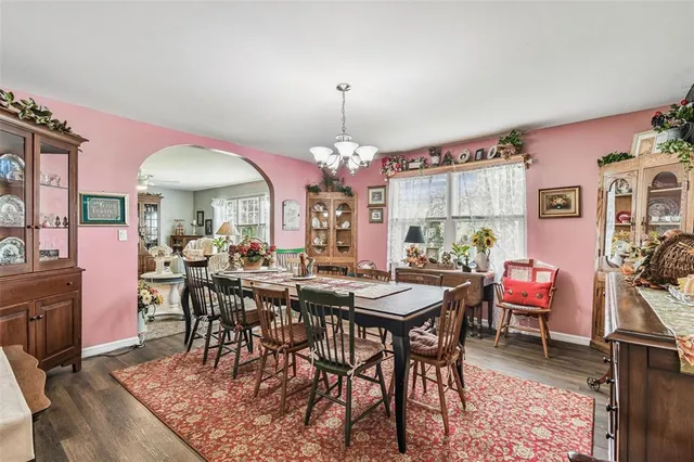 a view of a dining room with furniture and chandelier