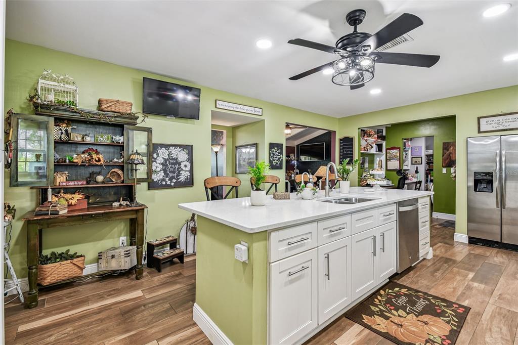 33937 St Benedict Road San Antonio, FL 33576 - Photo 15 of 58 a view of kitchen with stainless steel appliances kitchen island granite countertop a sink and cabinets