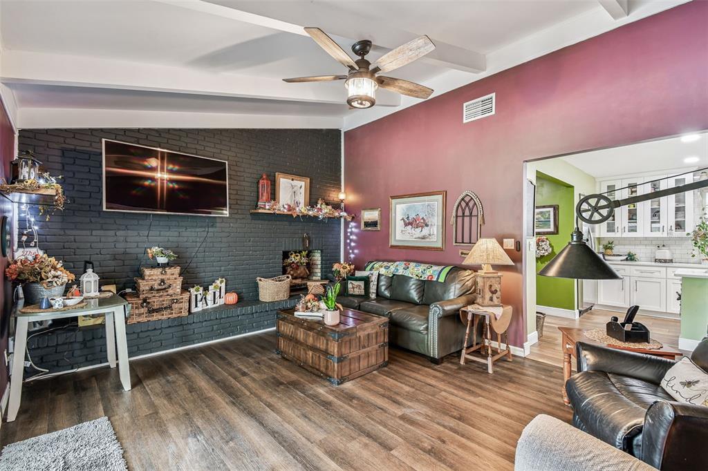 33937 St Benedict Road San Antonio, FL 33576 - Photo 20 of 58 a living room with furniture a flat screen tv and a fireplace