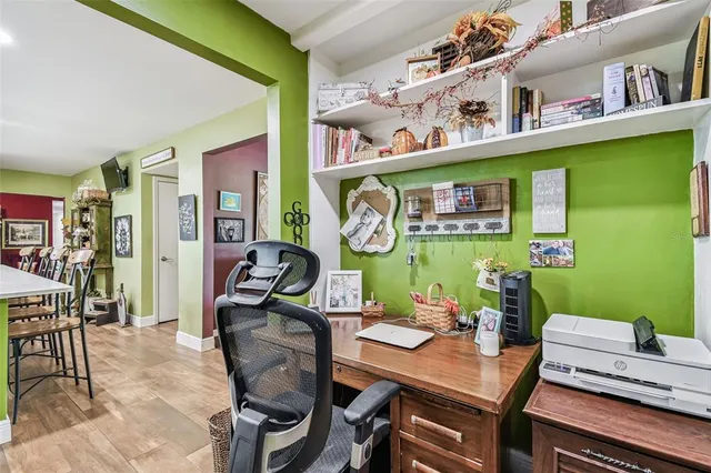 a bedroom with a large bed and wooden floor