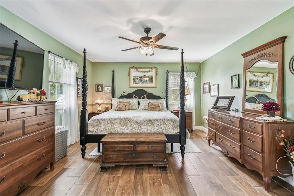 33937 St Benedict Road San Antonio, FL 33576 - Photo 26 of 58 a bedroom with a large bed and wooden floor