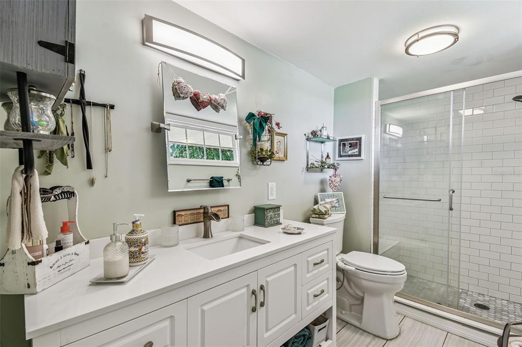 33937 St Benedict Road San Antonio, FL 33576 - Photo 28 of 58 a bathroom with a sink a toilet and shower
