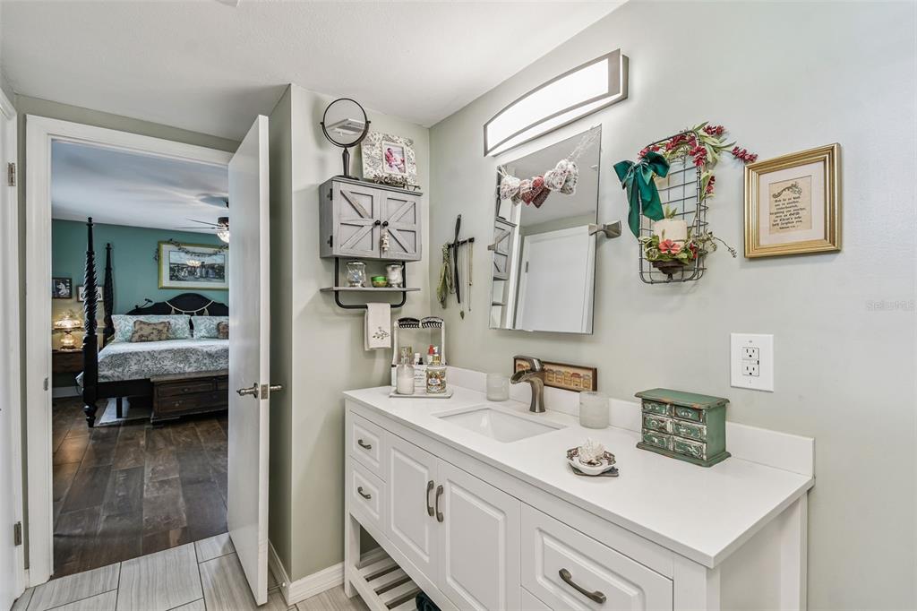 33937 St Benedict Road San Antonio, FL 33576 - Photo 30 of 58 a bathroom with a sink mirror and vanity