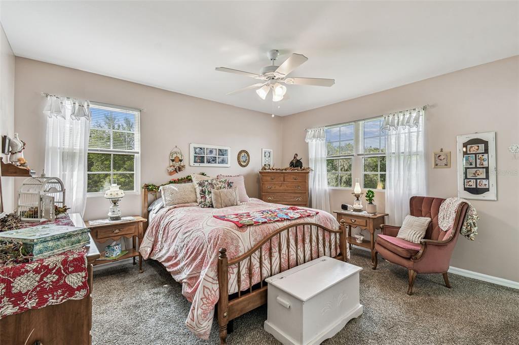 33937 St Benedict Road San Antonio, FL 33576 - Photo 31 of 58 a bedroom with a bed and a chandelier