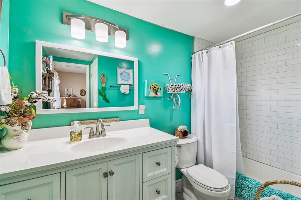 33937 St Benedict Road San Antonio, FL 33576 - Photo 33 of 58 a bathroom with a sink a toilet and a mirror
