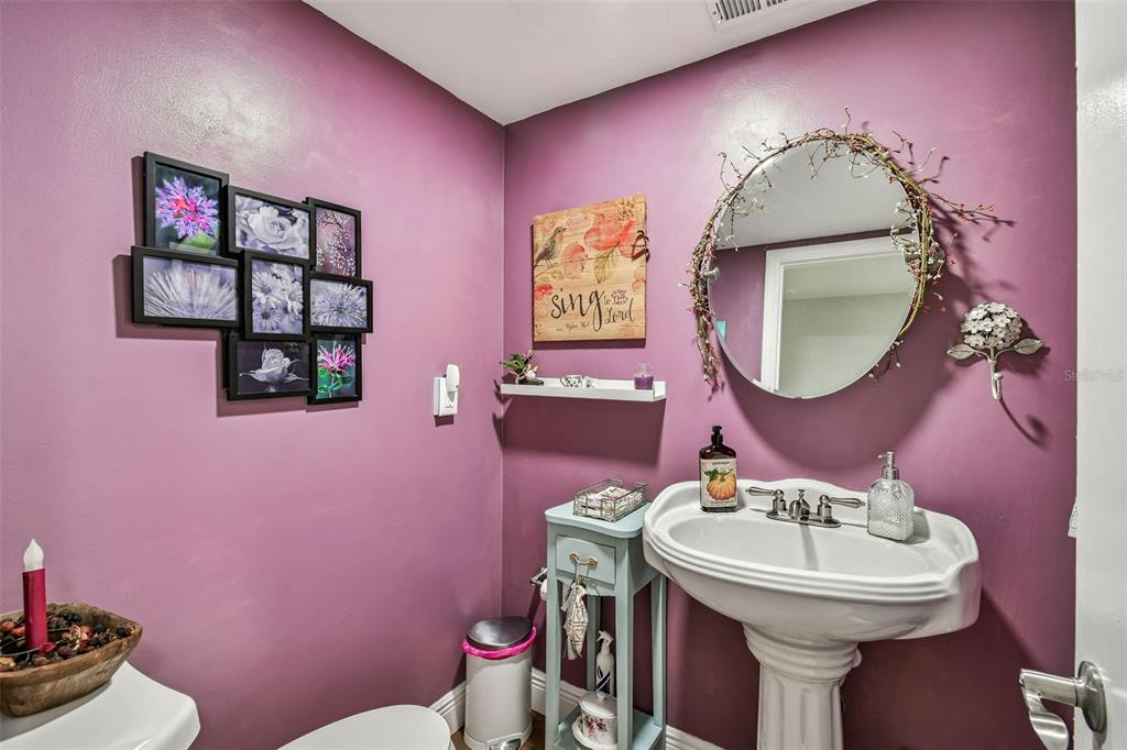 33937 St Benedict Road San Antonio, FL 33576 - Photo 34 of 58 a bathroom with a sink and mirror with toilet