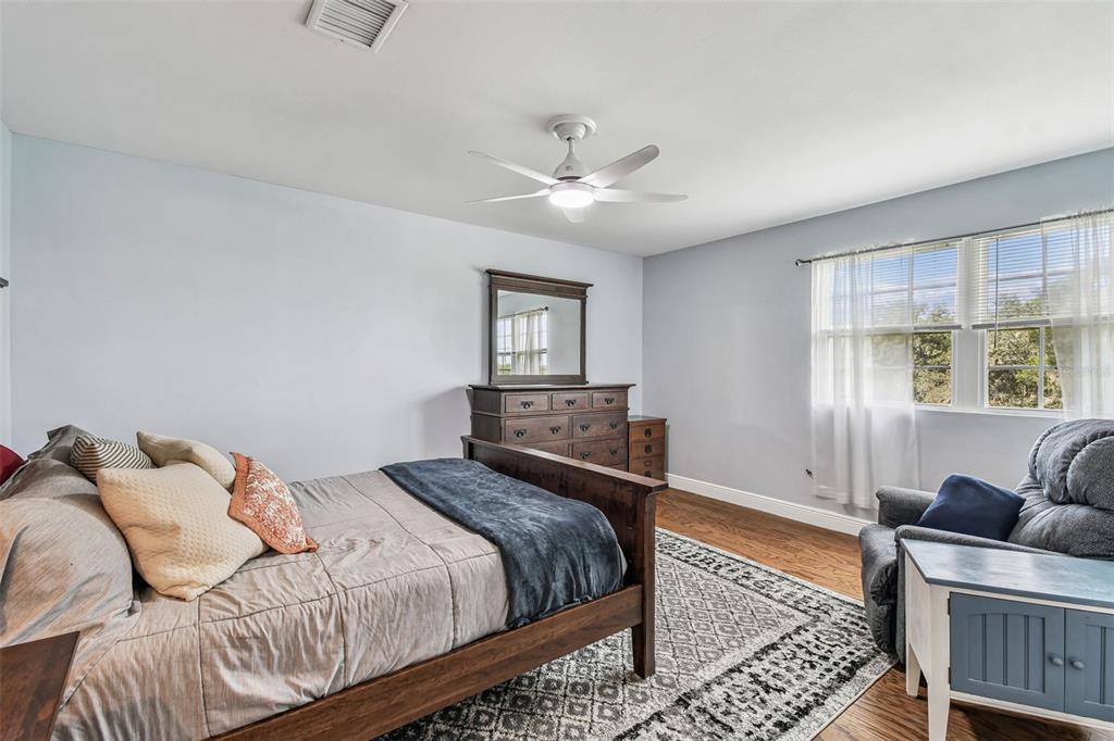 33937 St Benedict Road San Antonio, FL 33576 - Photo 37 of 58 a bedroom with a large bed and a window