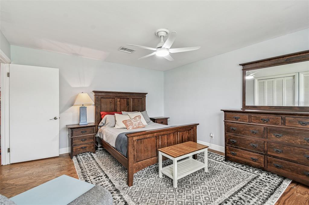 33937 St Benedict Road San Antonio, FL 33576 - Photo 39 of 58 a bedroom with a bed and a chandelier