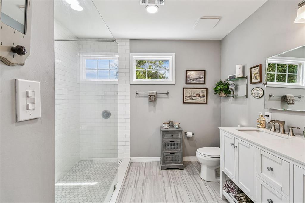 33937 St Benedict Road San Antonio, FL 33576 - Photo 40 of 58 a bathroom with a sink a toilet and shower