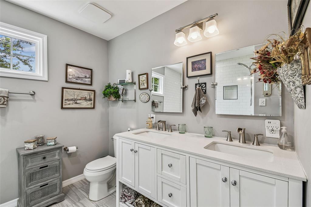 33937 St Benedict Road San Antonio, FL 33576 - Photo 41 of 58 a bathroom with a toilet sink and mirror