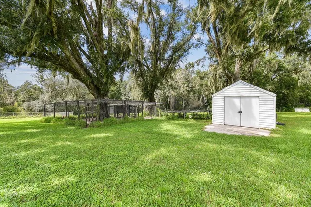 a view of a house with swimming pool and a yard
