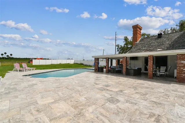 a backyard of a house with a yard and outdoor seating