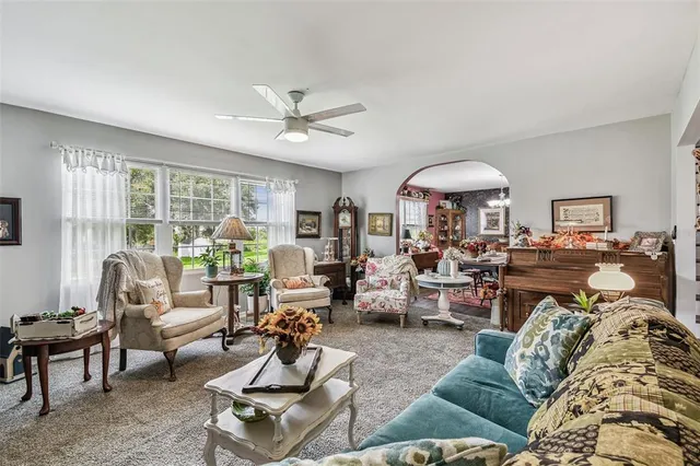 a living room with furniture and a chandelier