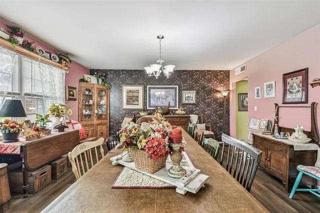 a view of a dining room with furniture and a chandelier
