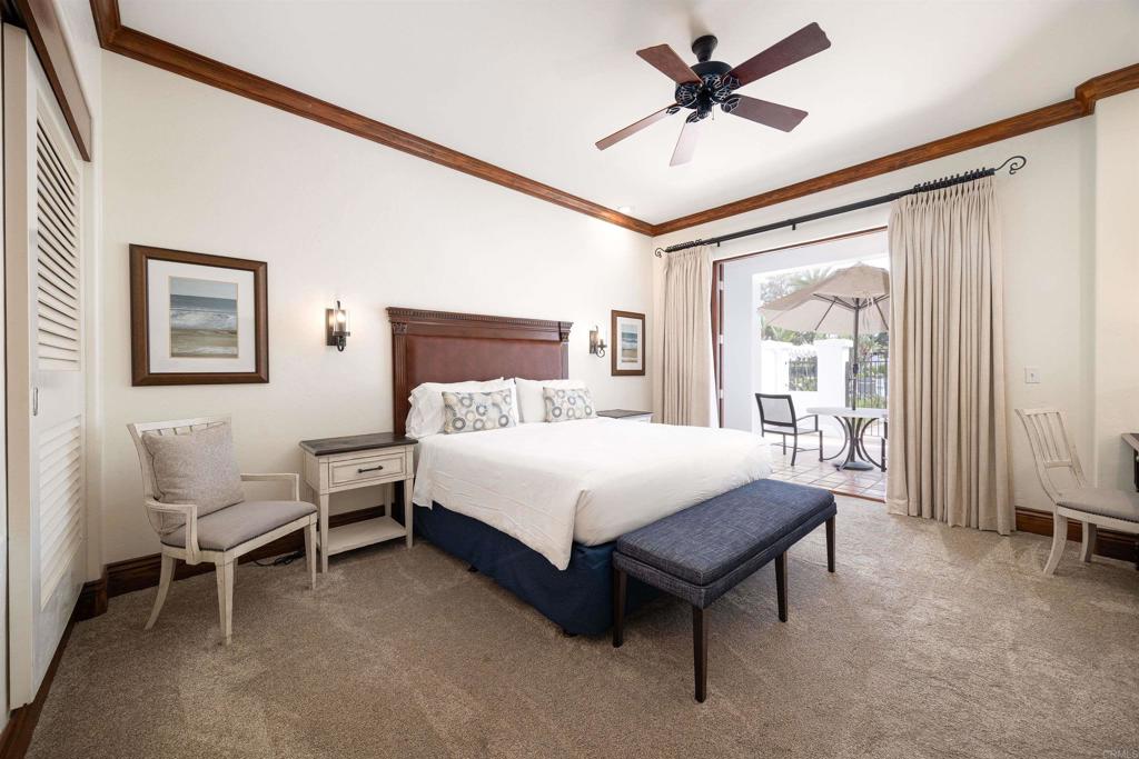 7310 Estrella De Mar Road, Unit 6 Carlsbad, CA 92009 - Photo 15 of 46 a spacious bedroom with a bed and a chandelier