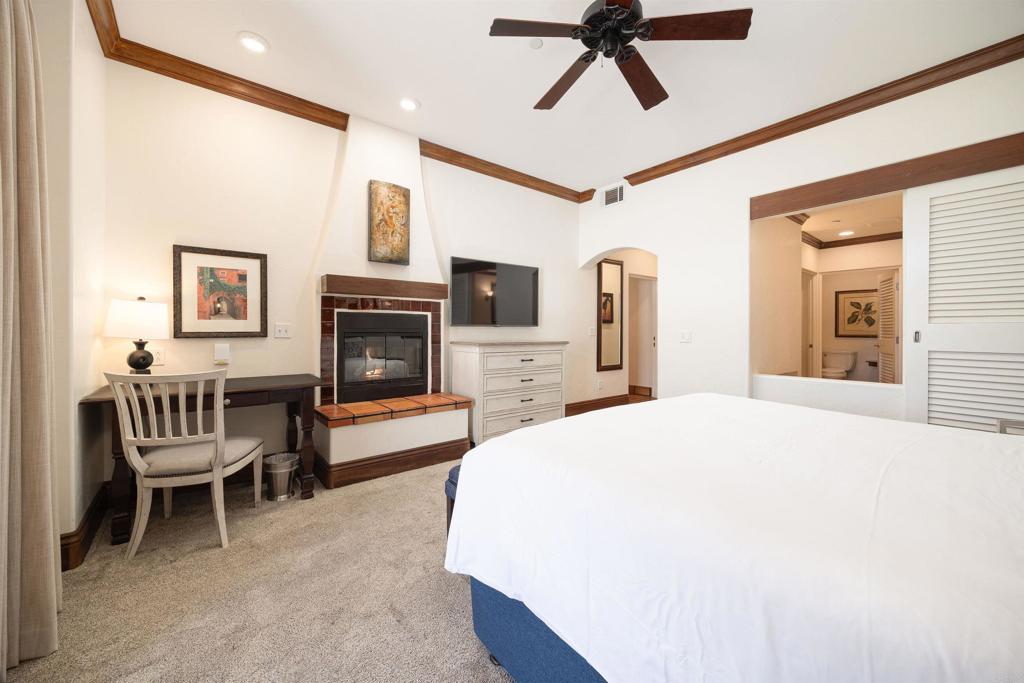7310 Estrella De Mar Road, Unit 6 Carlsbad, CA 92009 - Photo 16 of 46 a bedroom with a bed and a fireplace