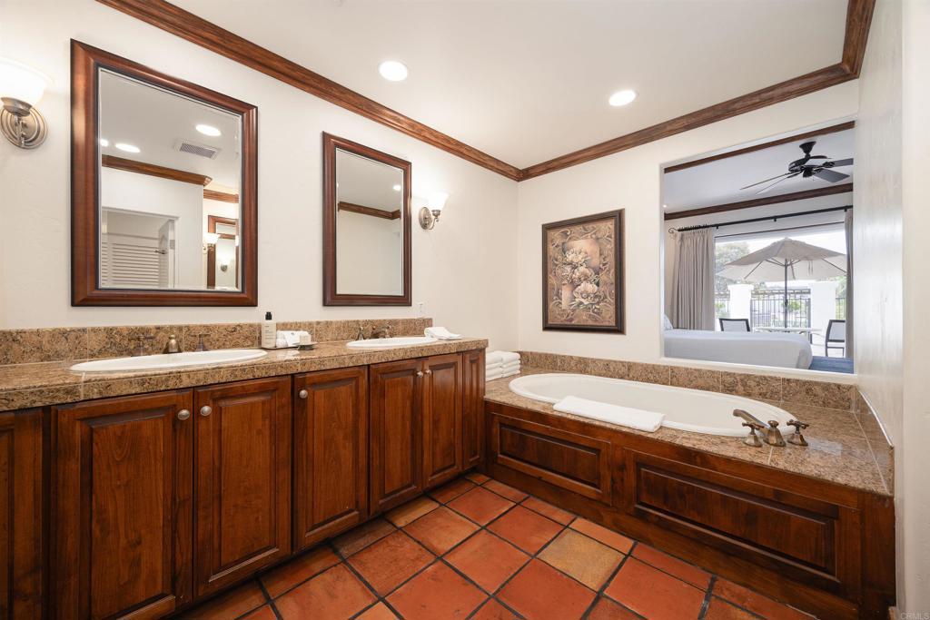 7310 Estrella De Mar Road, Unit 6 Carlsbad, CA 92009 - Photo 18 of 46 a spacious bathroom with a bathtub sink and mirror