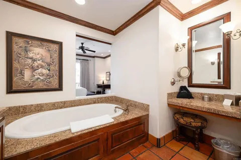 a bath tub sitting next to a bathroom sink