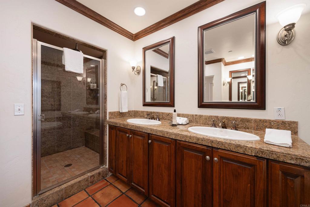 7310 Estrella De Mar Road, Unit 6 Carlsbad, CA 92009 - Photo 20 of 46 a bathroom with a granite countertop sink mirror and shower