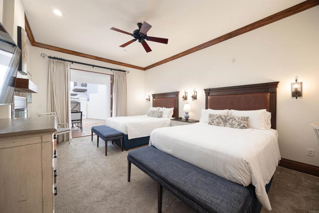 7310 Estrella De Mar Road, Unit 6 Carlsbad, CA 92009 - Photo 21 of 46 a bedroom with double bed and a couch