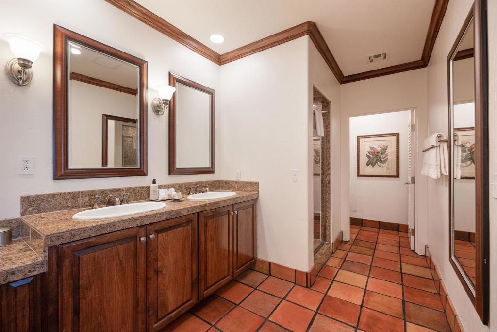 7310 Estrella De Mar Road, Unit 6 Carlsbad, CA 92009 - Photo 23 of 46 a bathroom with a sink and a mirror