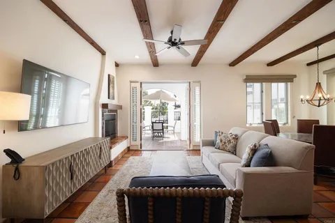a living room with furniture a flat screen tv and a large window