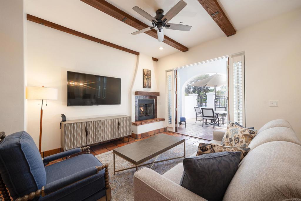 7310 Estrella De Mar Road, Unit 6 Carlsbad, CA 92009 - Photo 5 of 46 a living room with furniture and a flat screen tv