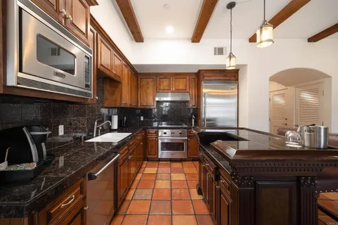 a kitchen with granite countertop a sink and stove