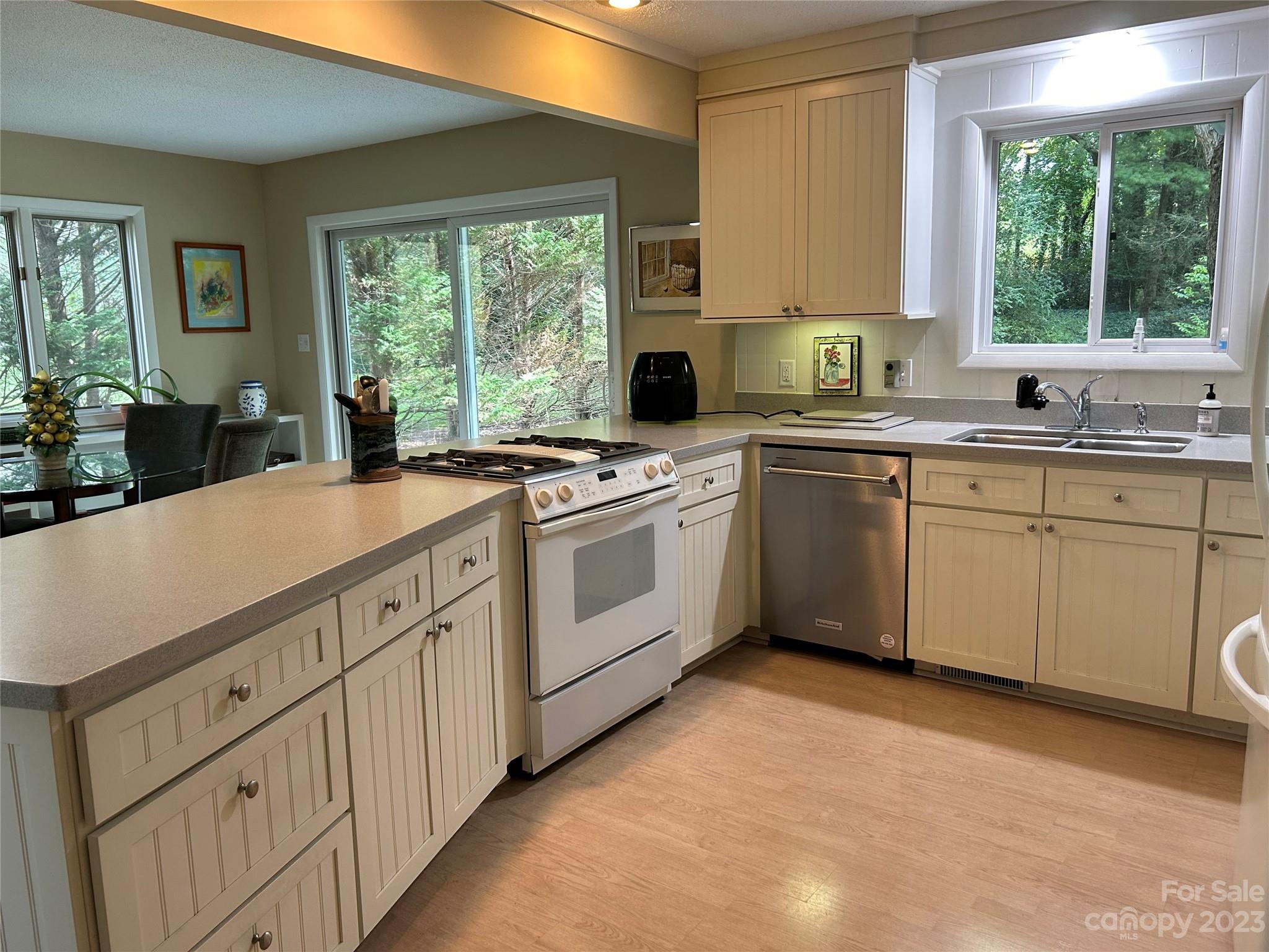 428 Brandon Road Hendersonville, NC 28739 - Photo 21 of 48 a kitchen with sink a window and cabinets