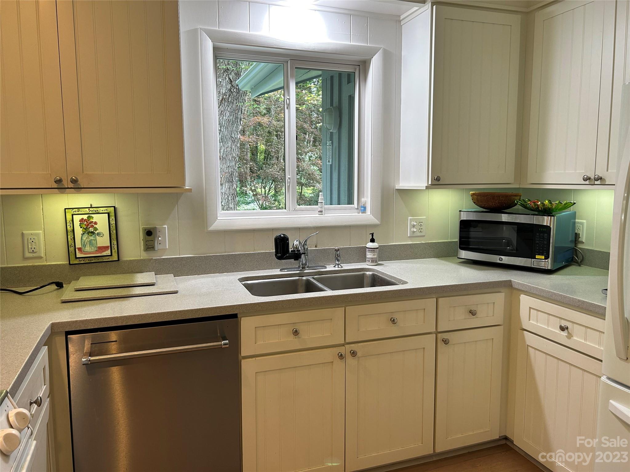 428 Brandon Road Hendersonville, NC 28739 - Photo 22 of 48 a kitchen with a sink stove and cabinets