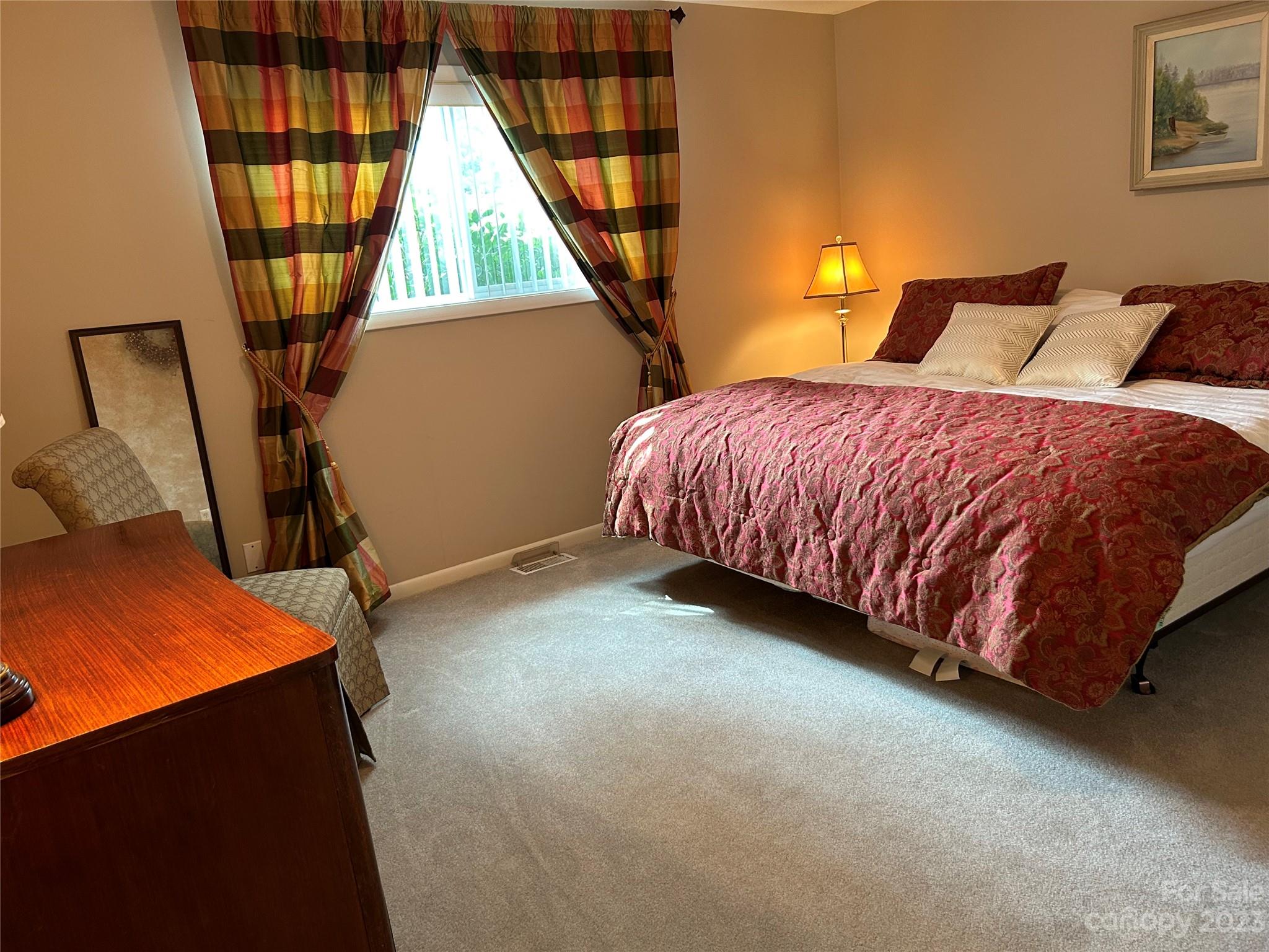 428 Brandon Road Hendersonville, NC 28739 - Photo 34 of 48 a bed sitting in a room next to a window