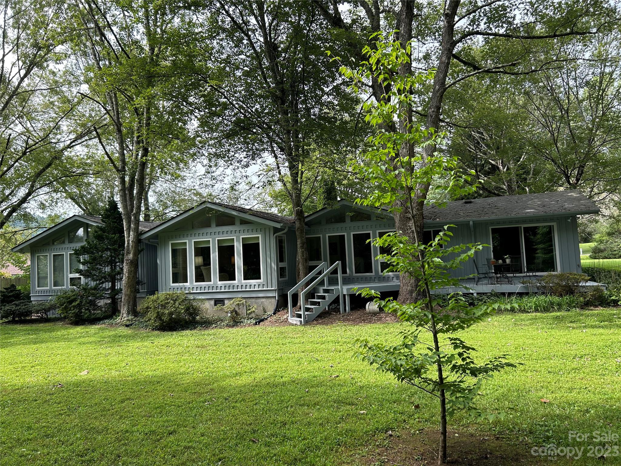 428 Brandon Road Hendersonville, NC 28739 - Photo 42 of 48 a front view of house with yard and green space
