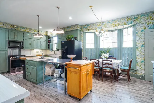 a kitchen with a sink stove and cabinets