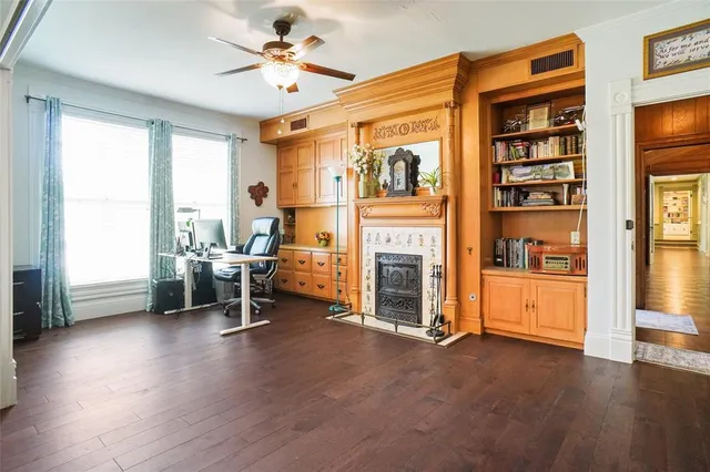 a bathroom with a granite countertop double vanity sink a mirror and a bathtub