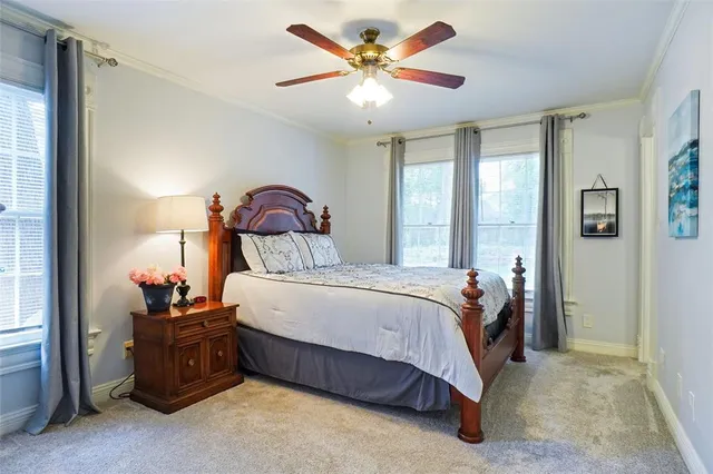 a bathroom with a granite countertop toilet sink and mirror