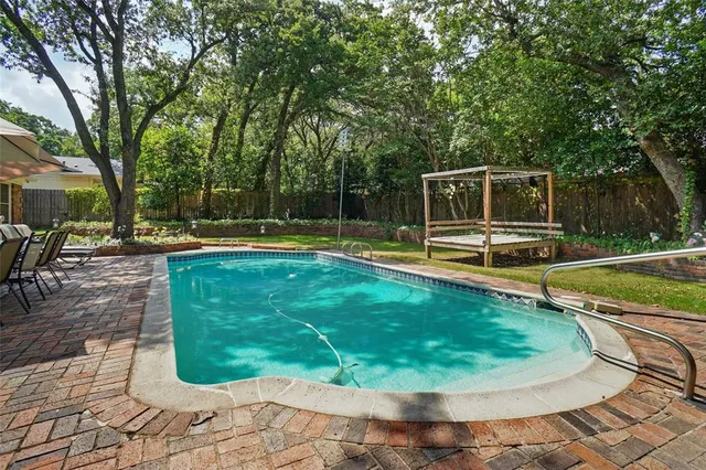 a view of a house with a patio and a yard
