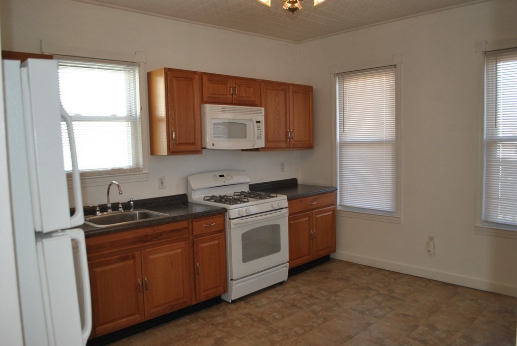 40 I Street, Unit 3 Boston, MA 02127 - Photo 4 of 11 a kitchen with stainless steel appliances granite countertop a sink a stove and a window